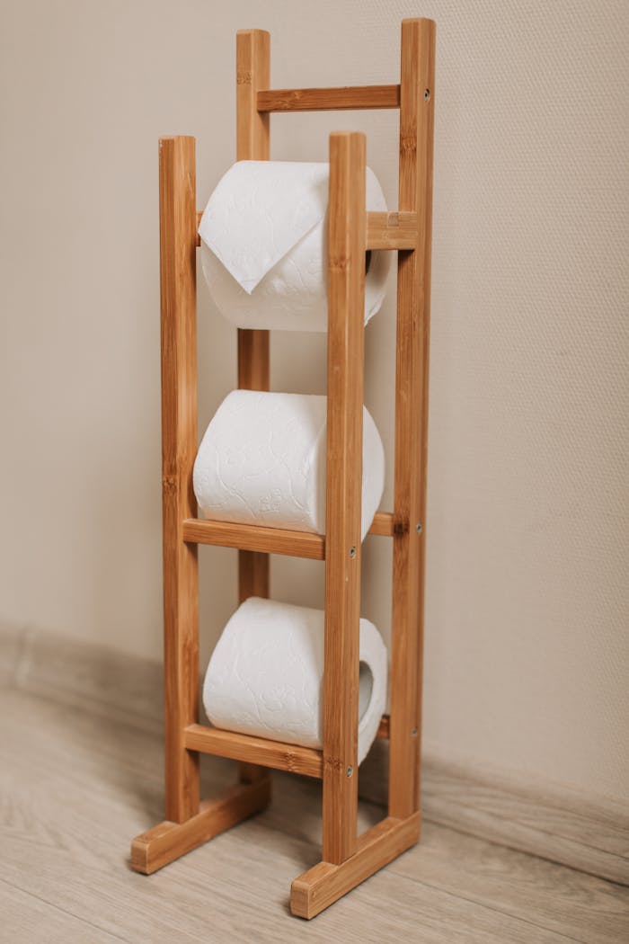 Elegant wooden rack displaying multiple toilet paper rolls. Ideal for bathroom essentials storage.